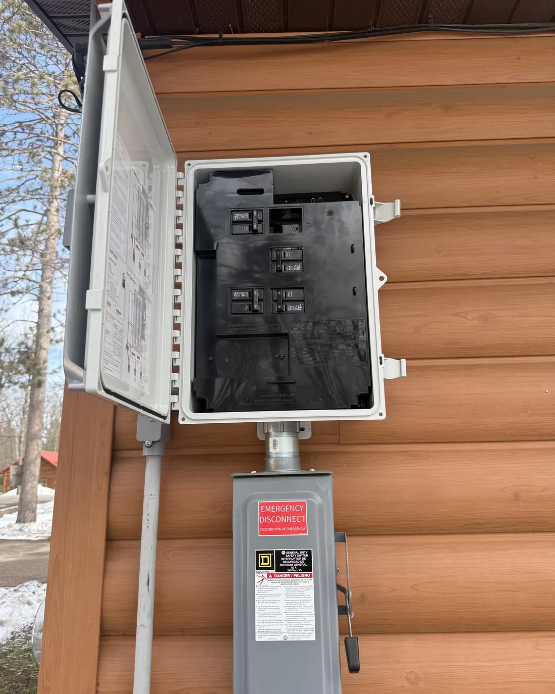 ICT Electric installed exterior service panel and emergency disconnect on a Northwoods log home